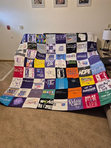 T-shirt quilt with cancer awareness, community service themes by Darcie from WI