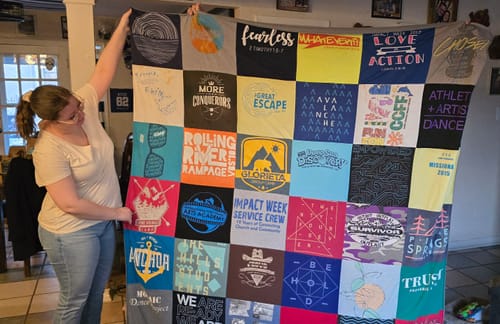 T-shirt quilt with outdoor activities, community service themes by Janet from TX