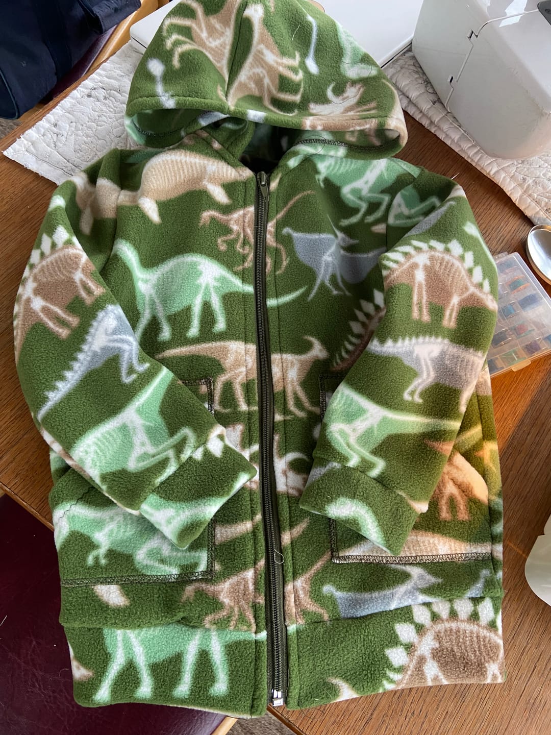 Customer photo review of Dino Skeletons on Green Anti Pill Polar Fleece Fabric
