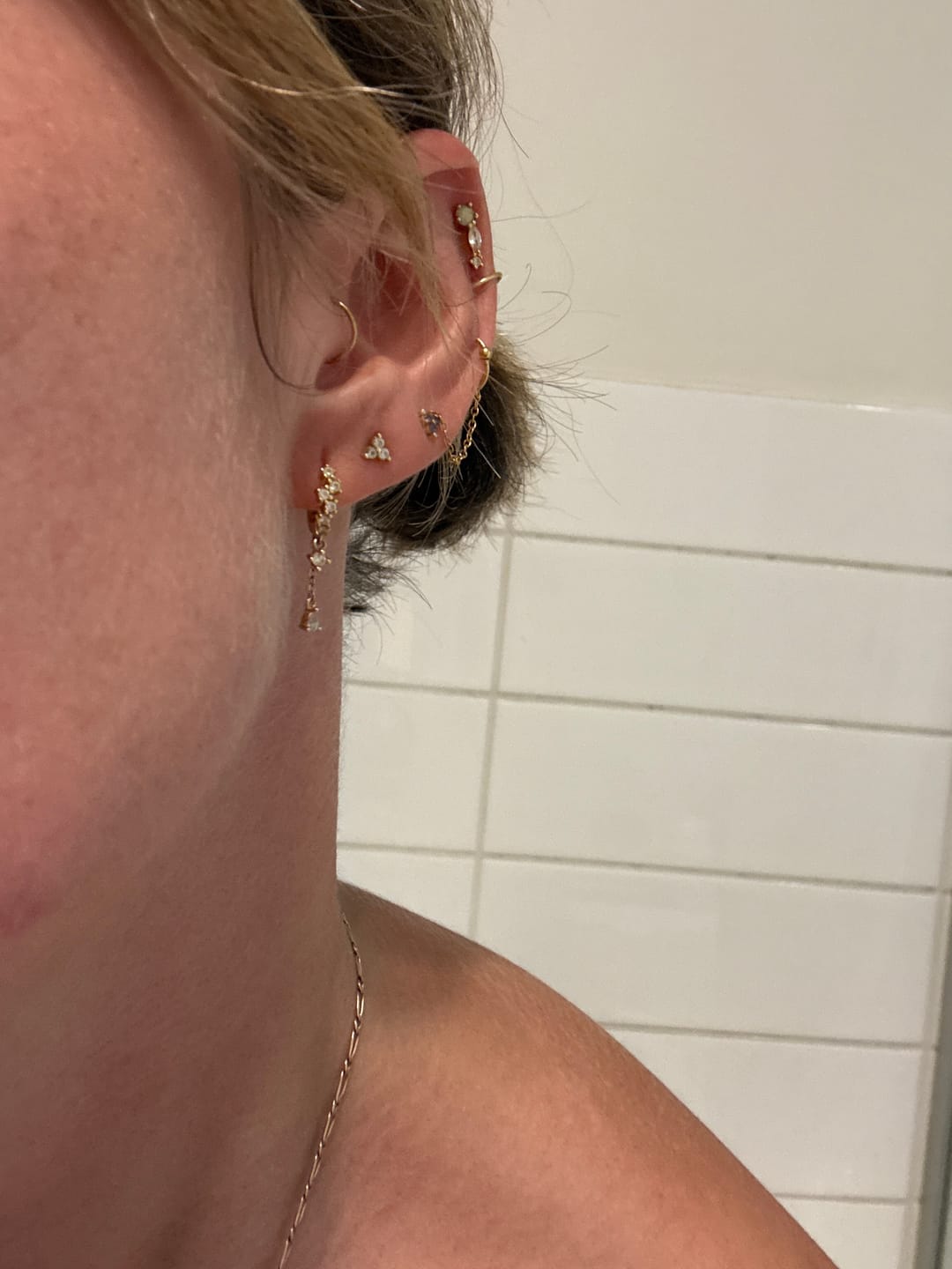 Customer photo review of Aura Sapphire Huggie Earrings