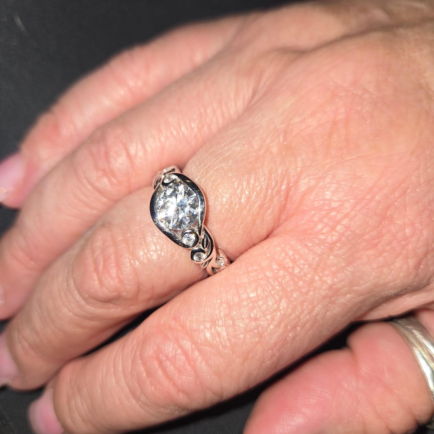 Customer photo review of Bezel Set Round Moissanite Scroll Accents Engagement Ring