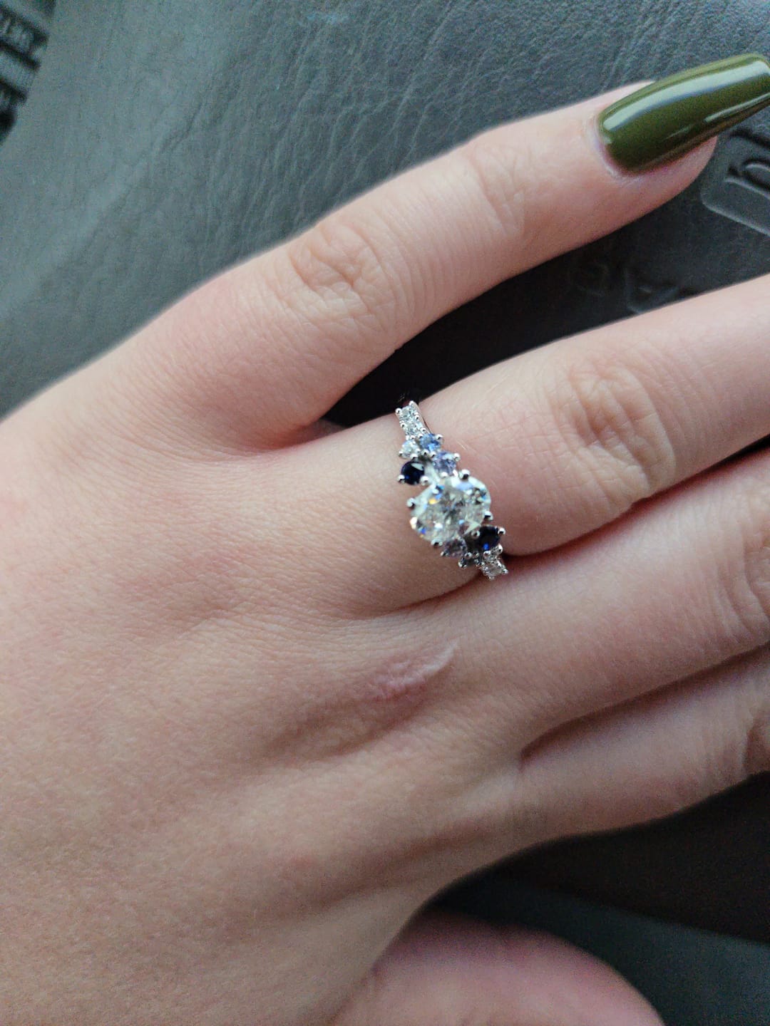 Customer photo review of Oval Moissanite And Graduated Blue Sapphire Clusters Engagement Ring
