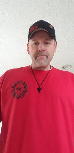 Customer photo review of In God We Trust - American Flag Cross  Necklace: Helps Pair Veterans With A Service Dog Or Shelter Dog
