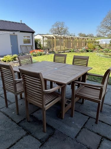 Customer photo review of Teak Square to Rectangle 120-170cm Extending Table 4cm Top (6 Oxford Stacking Chairs) Cushions included.