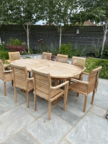 Customer photo review of Teak Oval 180-240cm Extending Table 4cm Top (8 Oxford Stacking Chairs) cushions included.
