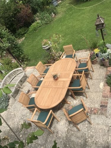 Customer photo review of Teak Oval 180-240cm Extending Table 4cm Top (8 Oxford Stacking Chairs) cushions included.