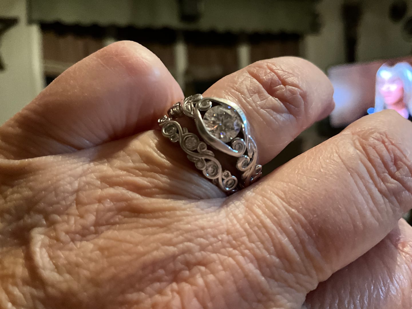 Customer photo review of Bezel Set Round Moissanite Scroll Accents Wedding Band Ring In Sterling Silver