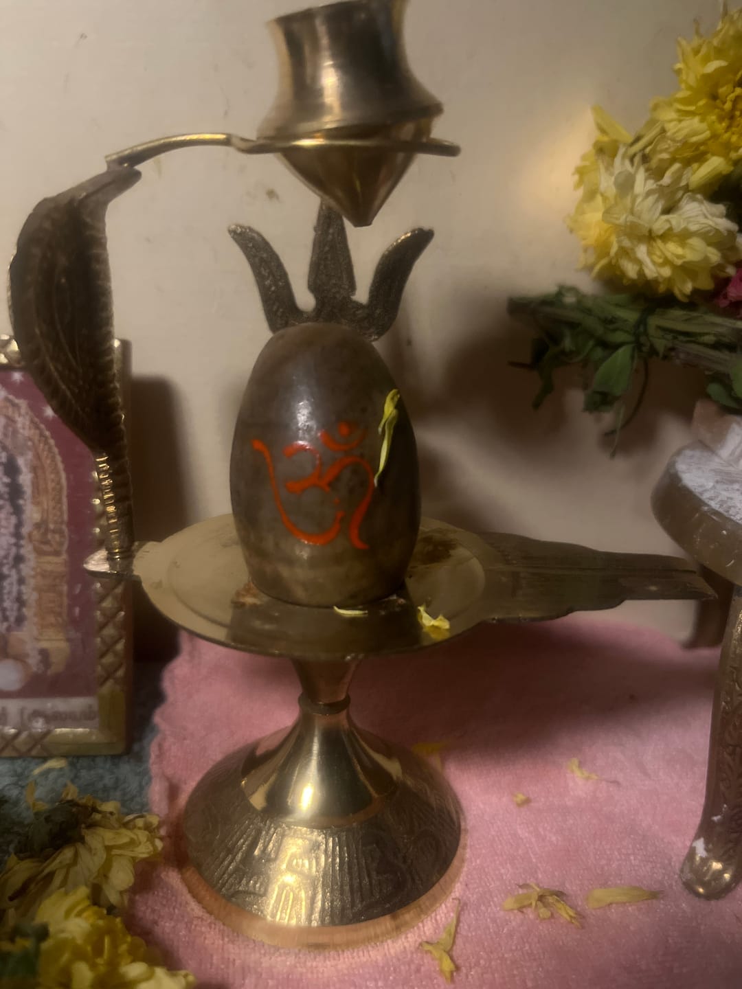 Customer photo review of Natural Stone Narmadeshwar Shivling with Small Golden Trishul & Temple Figurine (6 Inch)