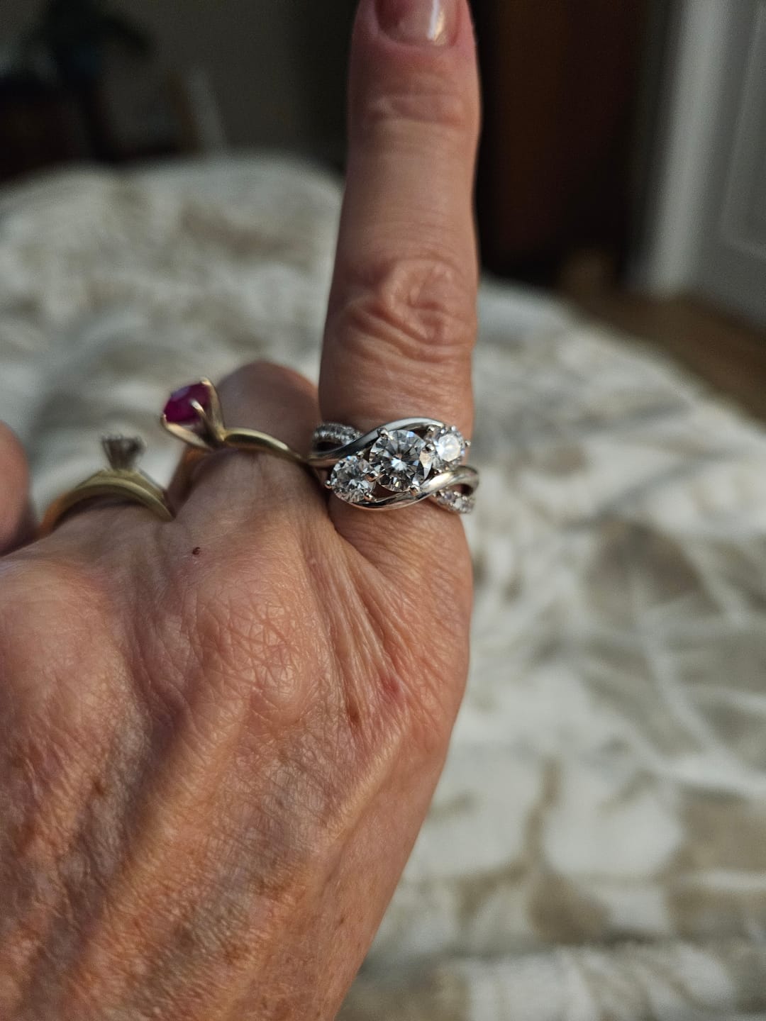 Customer photo review of Swirl Three Stone Moissanite Twisted Pave Engagement Ring