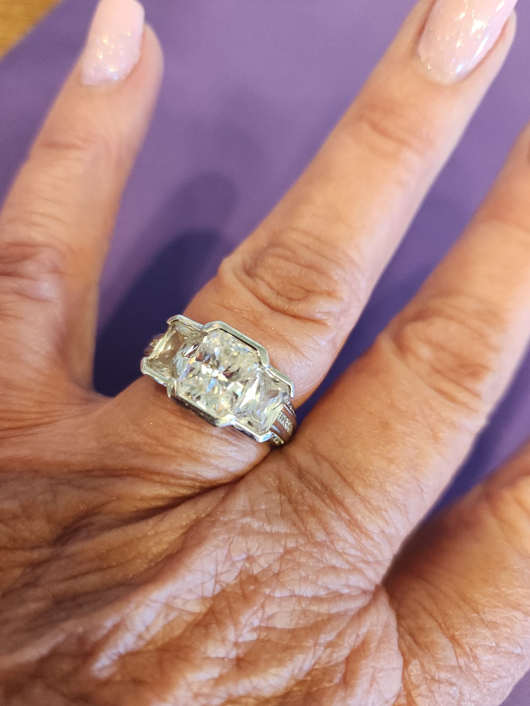 Customer photo review of Three Stone Radiant Moissanite Staircase Channel Set Euro Engagement Ring