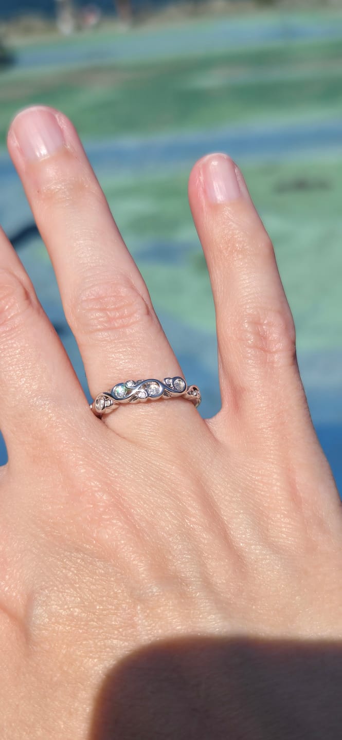 Customer photo review of Bezel Set Round Moissanite Scroll Accents Wedding Band Ring In Sterling Silver
