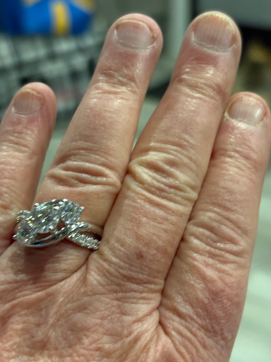 Customer photo review of Swirl Three Stone Moissanite Twisted Pave Engagement Ring
