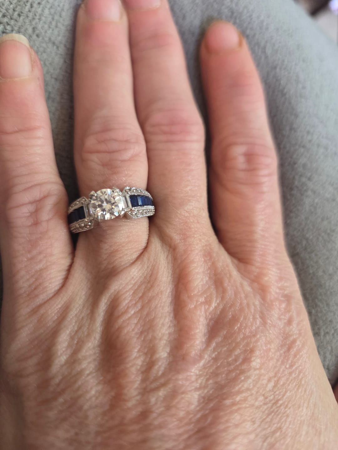 Customer photo review of Round Moissanite And Emerald-Cut Sapphire Channel Set Milgrain Engagement Ring