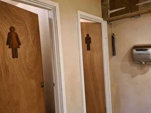 Customer photo review of Rusty Metal Man & Lady Toilet Sign