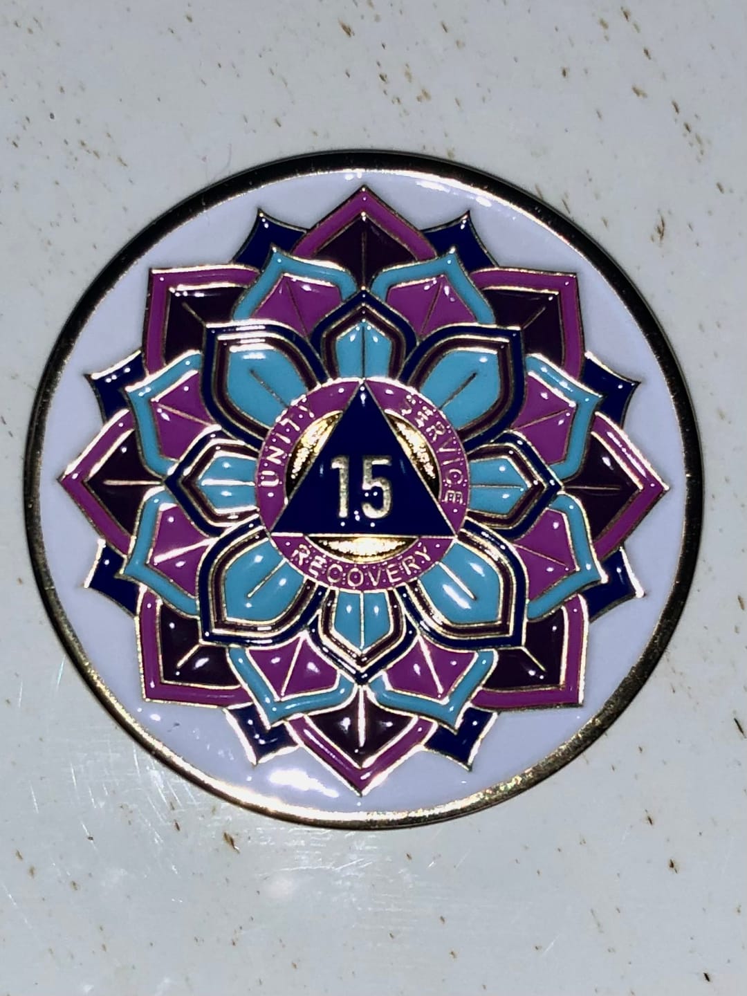 Customer photo review of 15 Year Sobriety Mint 'In Bloom' Lotus Flower Gold Plated AA Recovery Medallion - Fifteen Year Chip/Coin - White