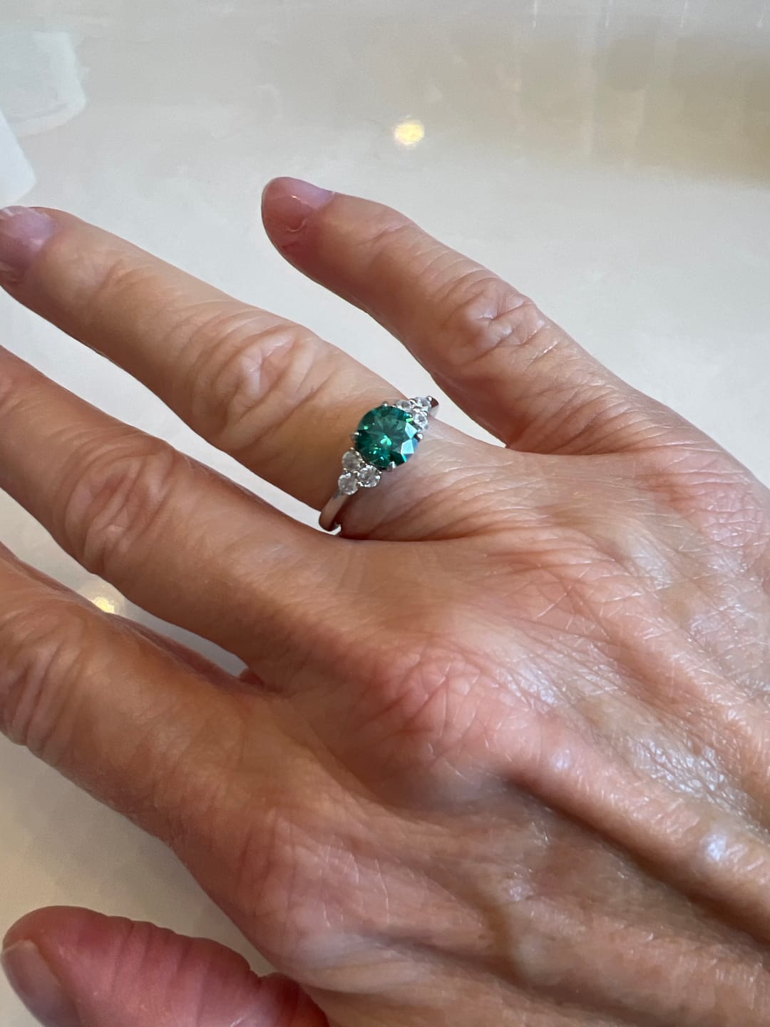 Customer photo review of Green Moissanite Side Stone Engagement Ring