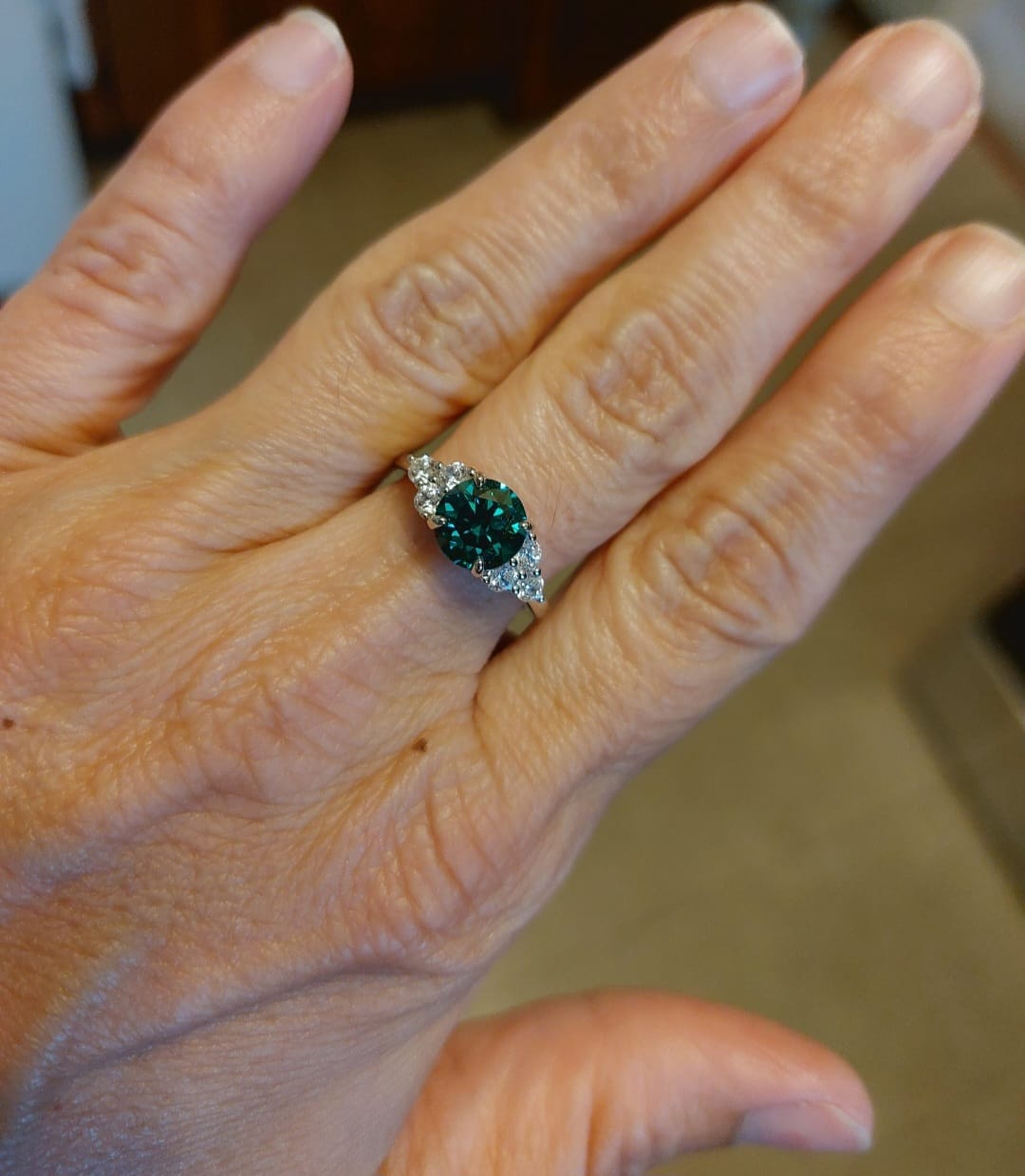 Customer photo review of Green Moissanite Side Stone Engagement Ring
