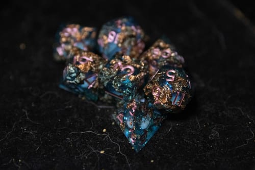 Customer photo review of URWizards D&D Pale Blue Liquid Heart Resin Engraved Dice Set Copper Flakes