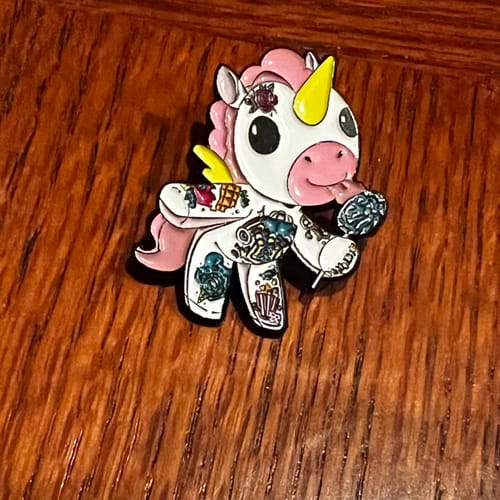 Customer photo review of Candy the Unicorn Enamel Pin