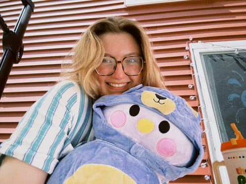 Customer photo review of Purple Finch Plushie – Soft & Cuddly with Purple Bear Costume