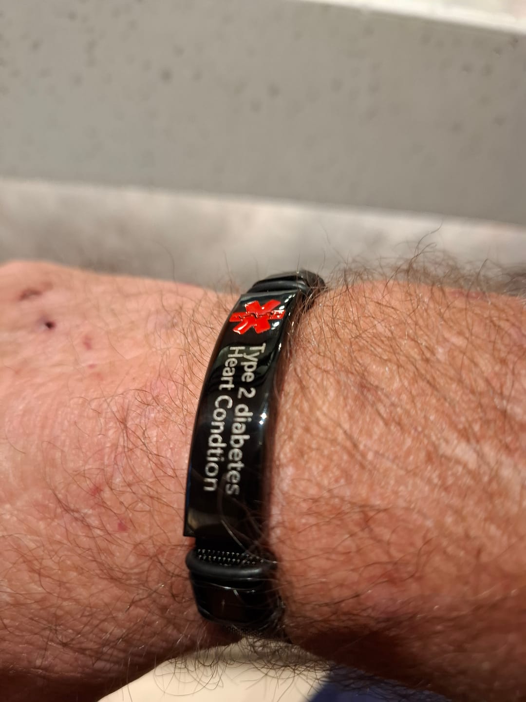 Customer photo review of Personalised Black Mesh Medical Alert Bracelet - Red Logo