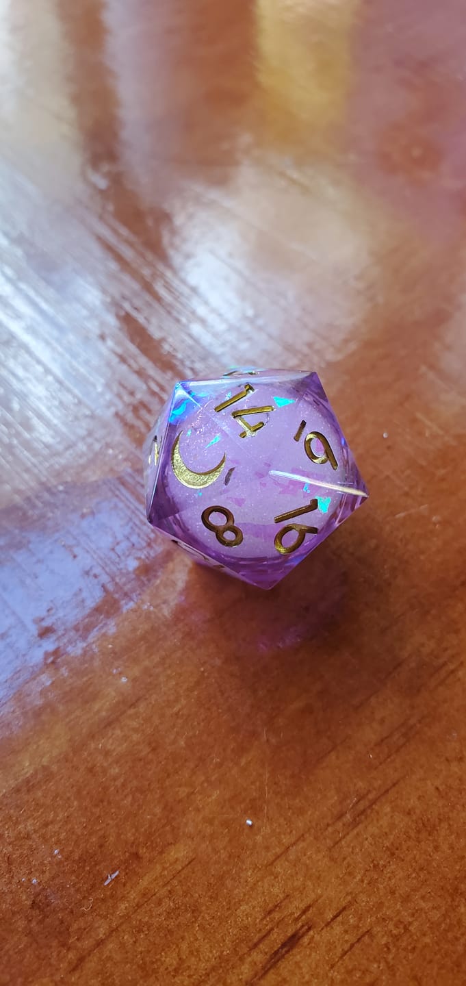 Customer photo review of URWizards D&D Purple Glitter Liquid Heart Resin Engraved Dice Set Moon