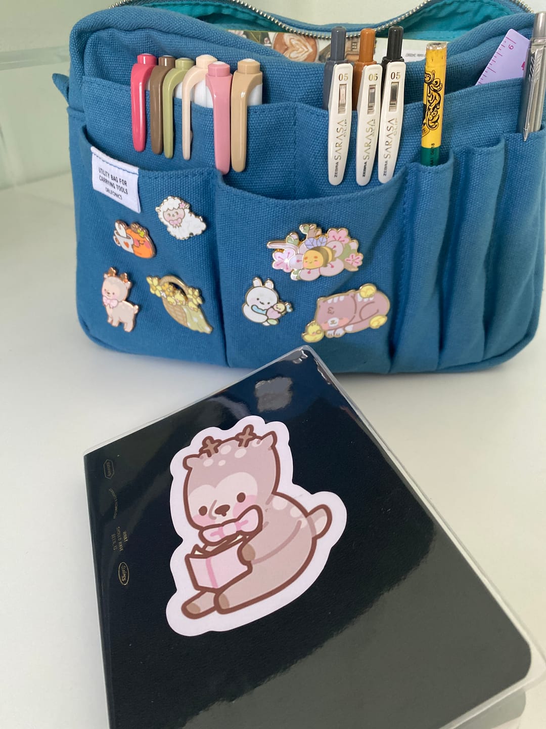 Customer photo review of Cinnamon the Chubby Reindeer Die-Cut Sticker | Book Lover Gift | Pink Coquette Bow | Christmas Stationery Sticker