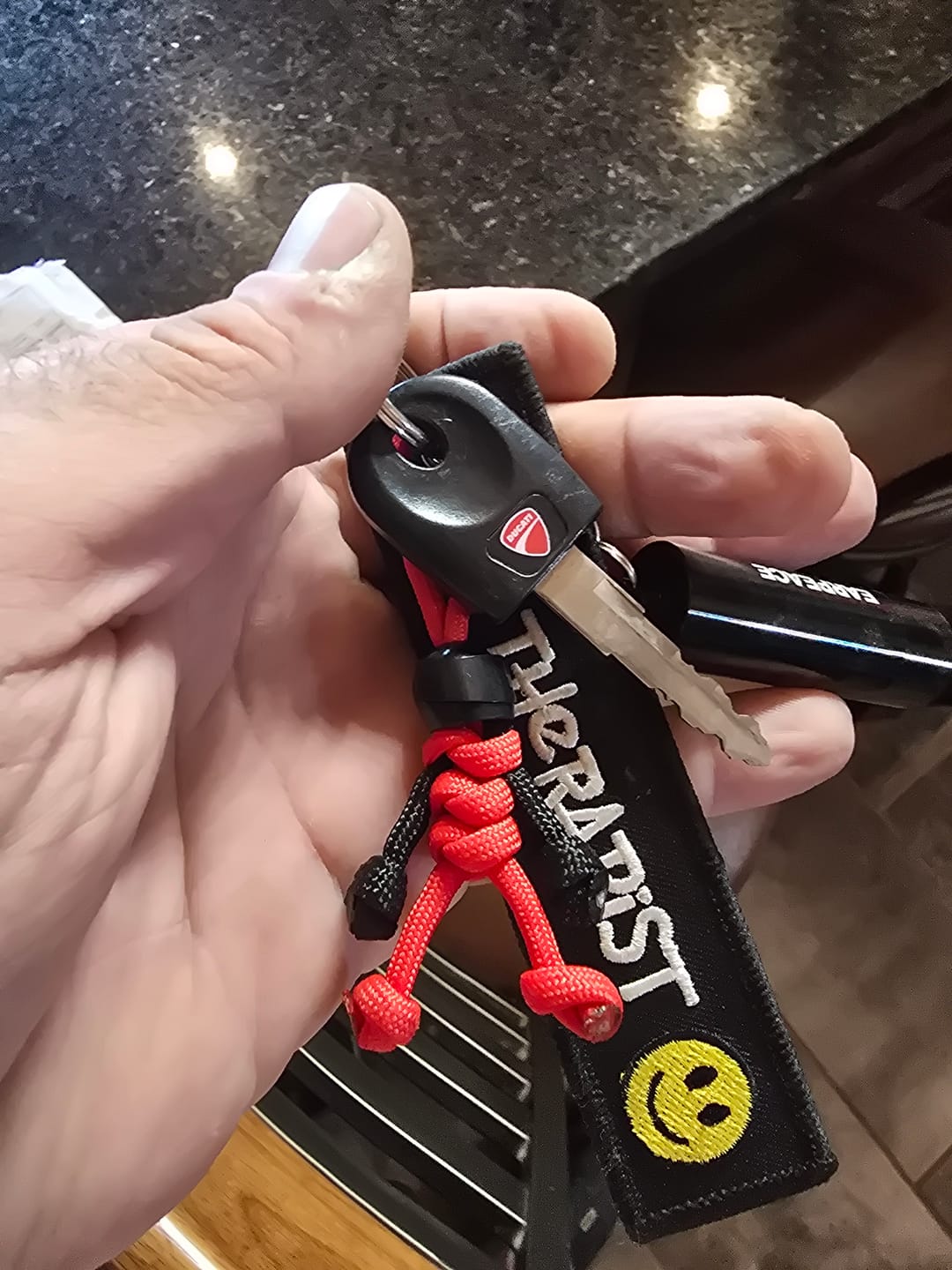 Customer photo review of Black Red Biker Buddy Paracord Keychain