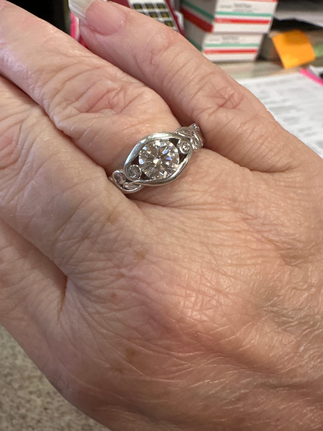 Customer photo review of Bezel Set Round Moissanite Scroll Accents Engagement Ring