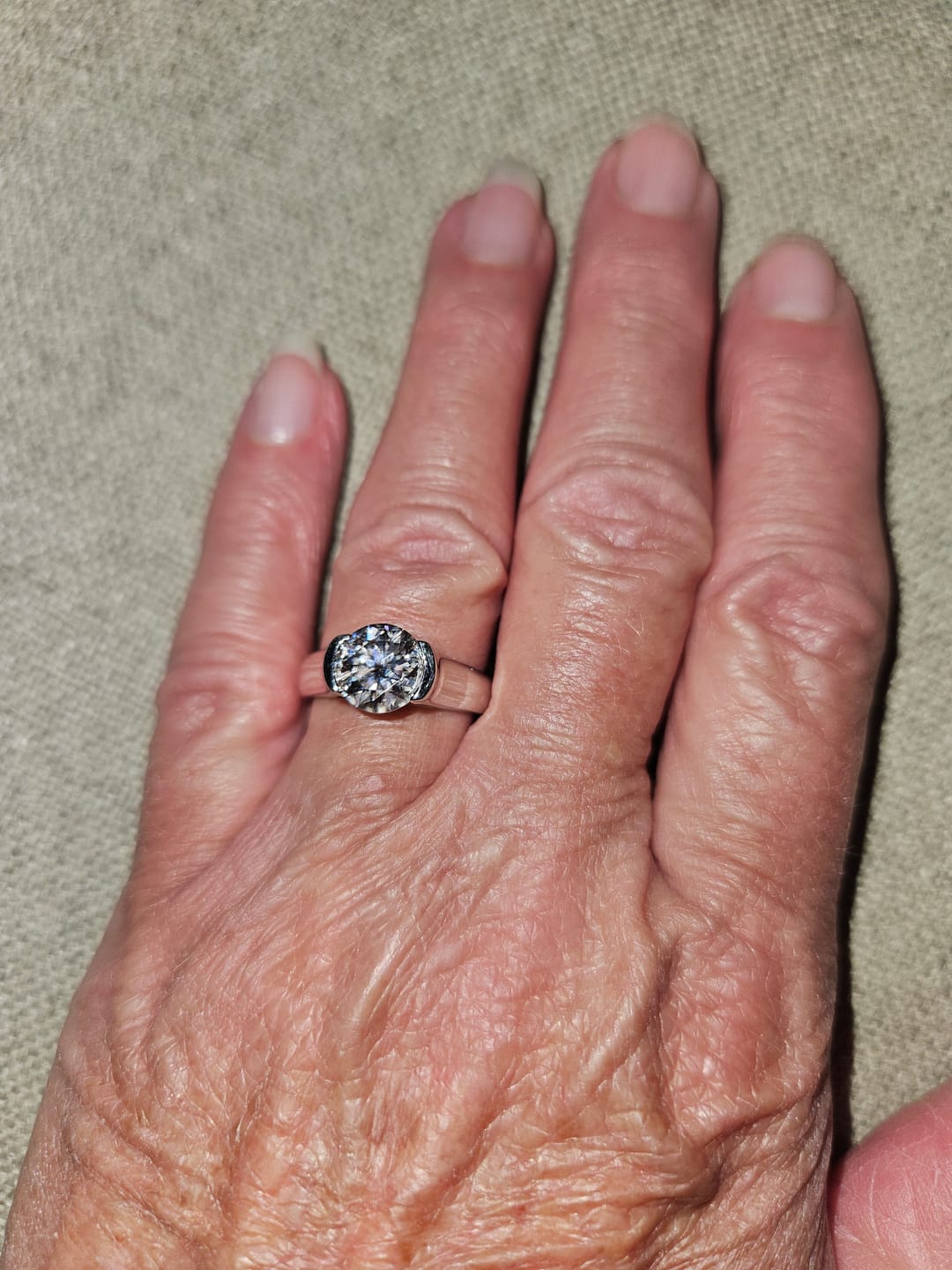 Customer photo review of Solitaire Moissanite Half Bezel Set Sterling Silver Engagement Ring