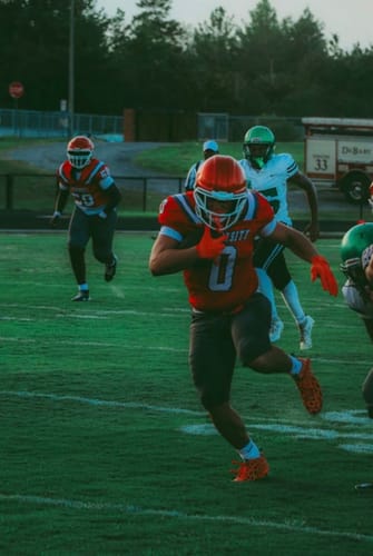 Customer photo review of The Flintstones "Bedrock Blitz" Football Cleats - Quantum Speed by Phenom Elite