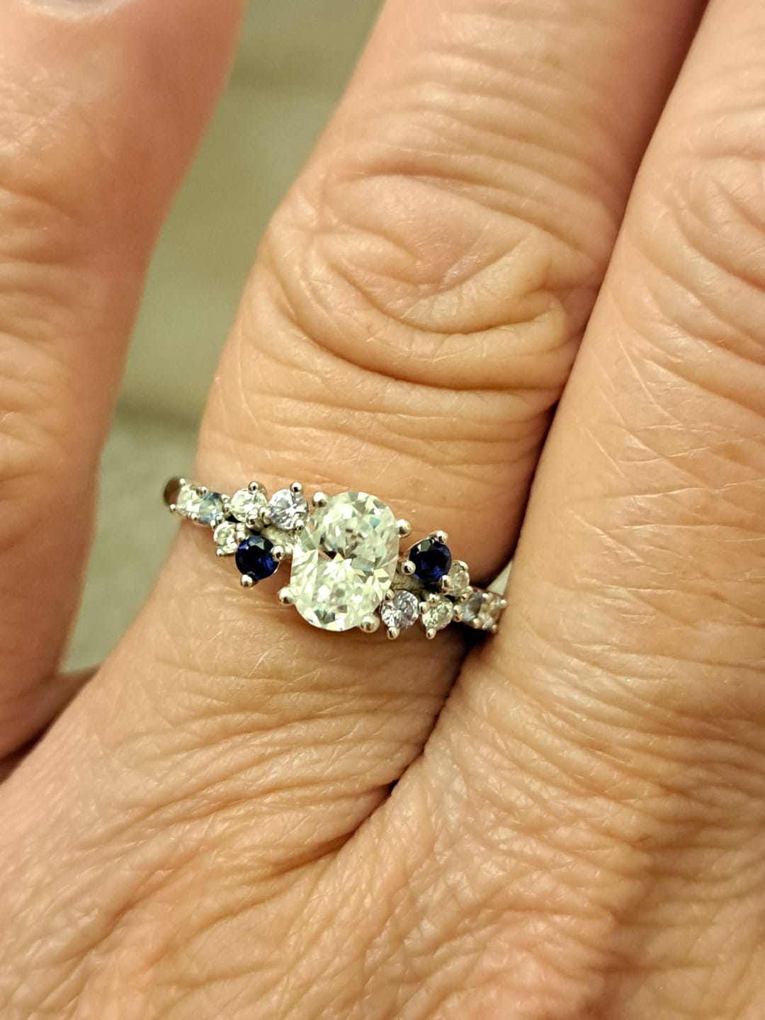 Customer photo review of Oval Moissanite And Graduated Blue Sapphire Clusters Engagement Ring