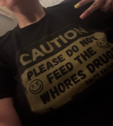 Customer photo review of Salty Savage Unisex "PLEASE DO NOT FEED THE WHORES DRUGS" Tee