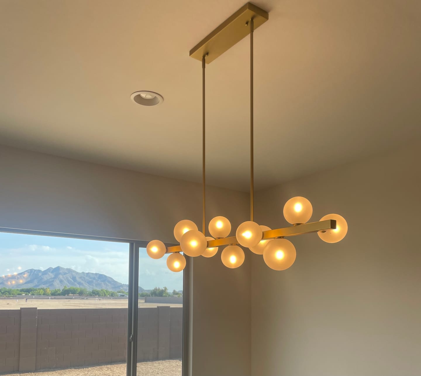 Customer photo review of 12-Light Brass Frosted Glass Bubble Linear Chandelier