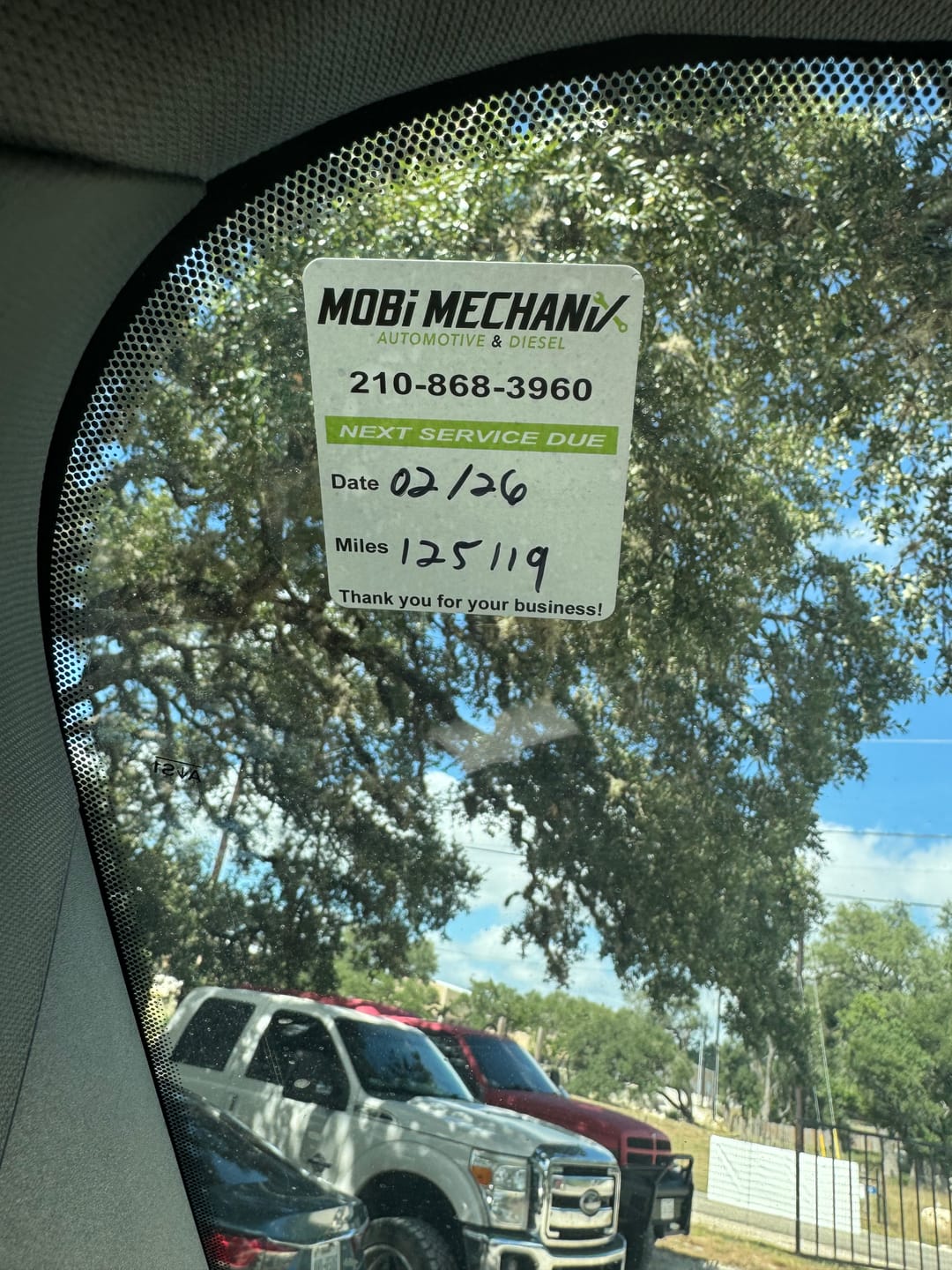 Customer photo review of Custom Oil Change Stickers for Windshield with Logo