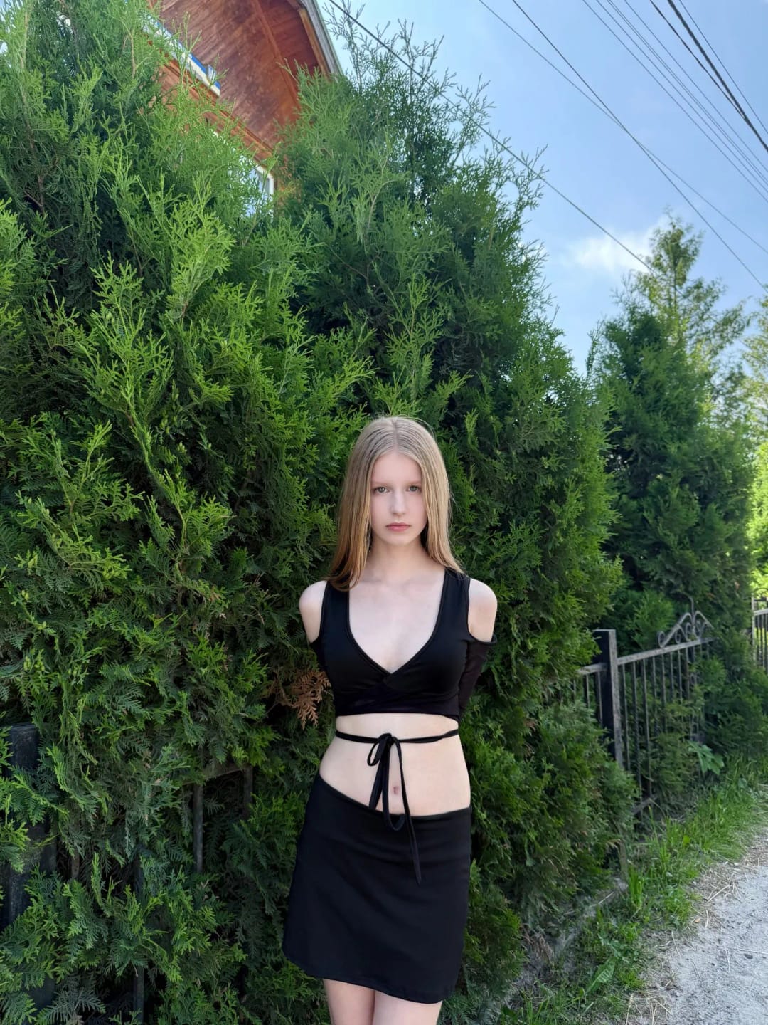 Customer photo review of Lace-Up Bandage Knit Crop Top With V-Neck Cut-Out Long Sleeve And Subtle Sheen — Black | KIMLUD
