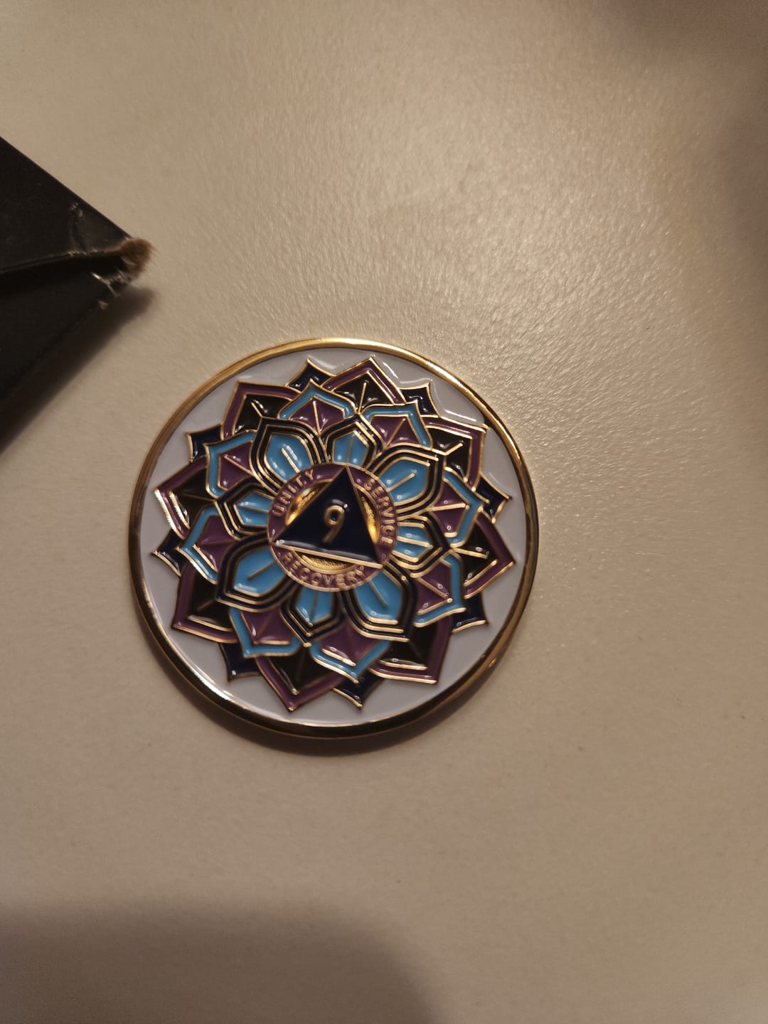 Customer photo review of 9 Year Sobriety Mint 'In Bloom' Lotus Flower Gold Plated AA Recovery Medallion - Nine Year Chip/Coin - White
