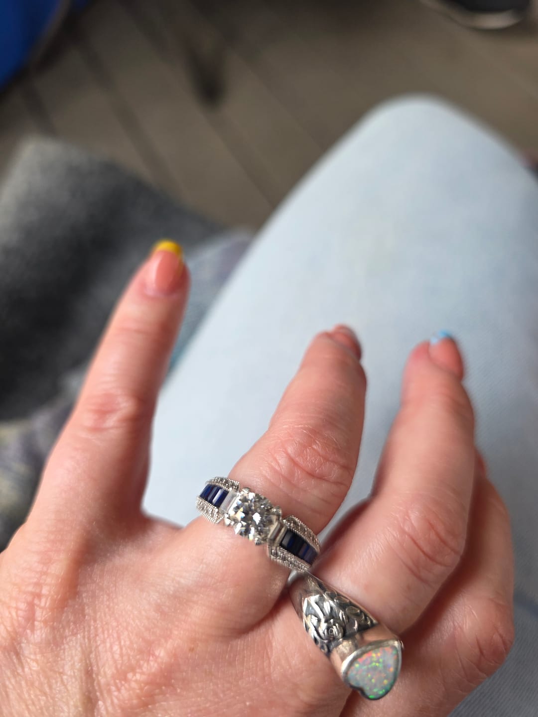 Customer photo review of Round Moissanite And Emerald-Cut Sapphire Channel Set Milgrain Engagement Ring