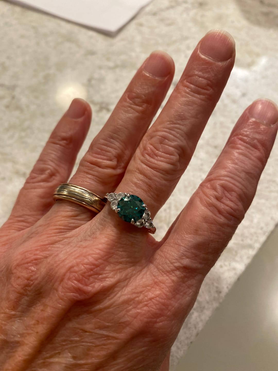 Customer photo review of Green Moissanite Side Stone Engagement Ring