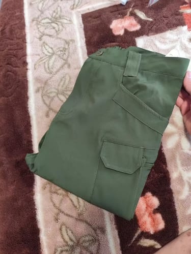 Folded green cargo trousers