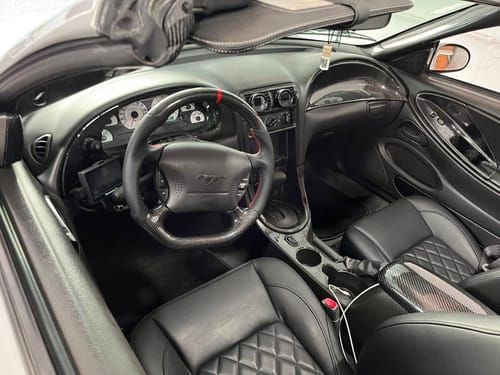 Customer photo review of Carbon Fiber Flat Bottom Steering Wheel for 1994-2004 Ford Mustang SN95 & New Edge | Red Top Stripe, Black Perforated Leather, Red Stitching