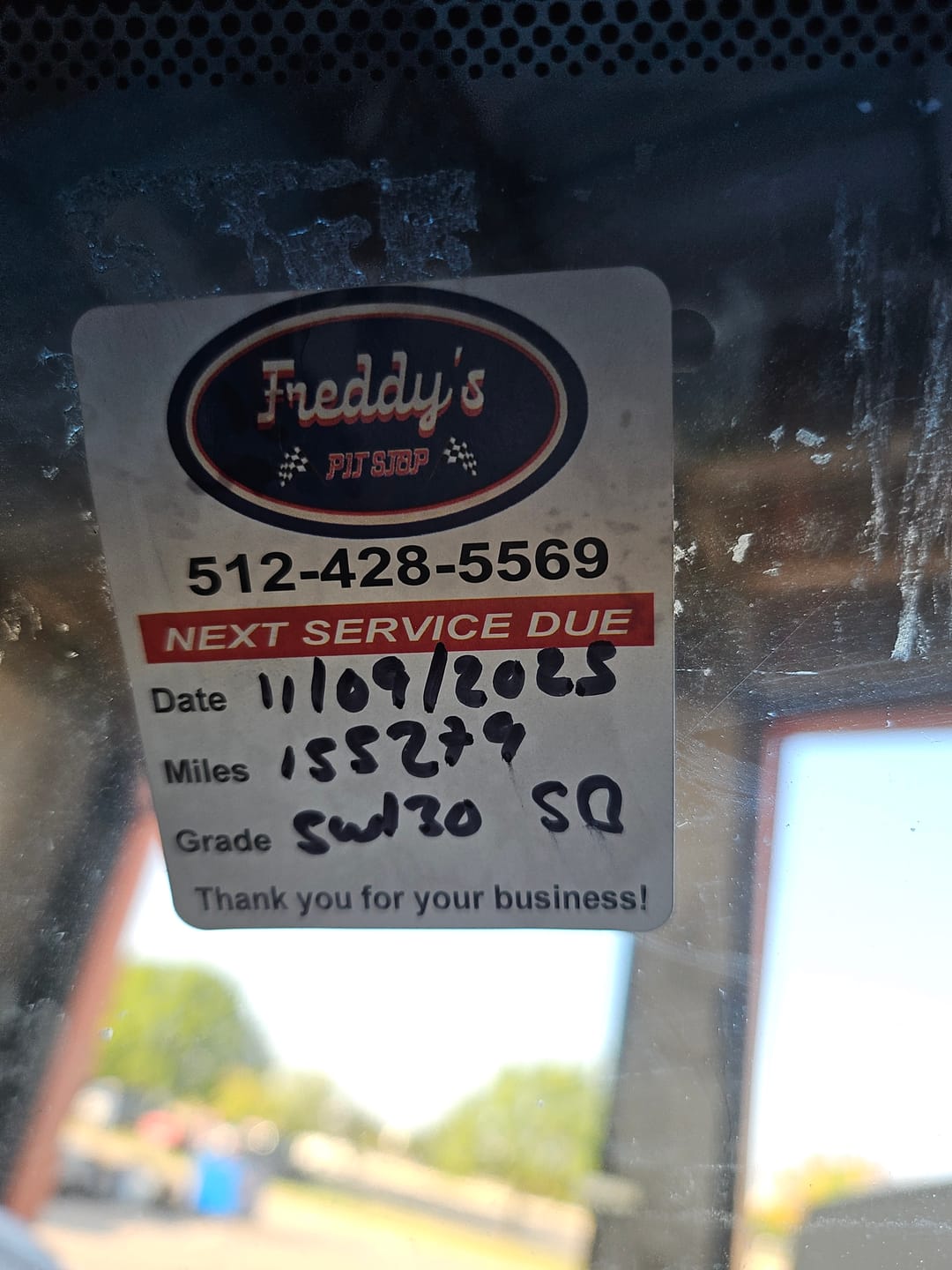 Customer photo review of Custom Oil Change Stickers for Windshield with Logo