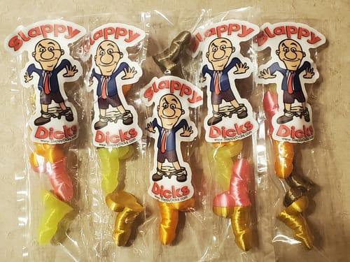 Customer's custom vinyl stickers with a cartoon character applied to five individually wrapped advertising samples.