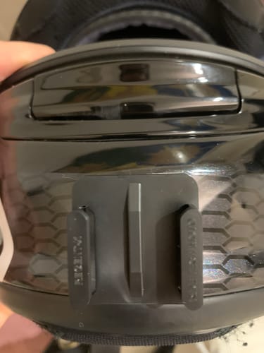 Close-up of a customer's black Arai camera mount attached to the chin of a glossy motorcycle helmet.