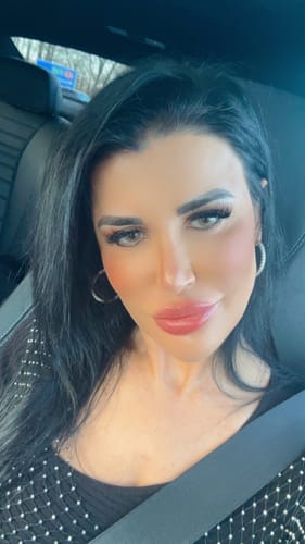 Reviewer takes a selfie in a car, showing off their Ocean contact lenses.