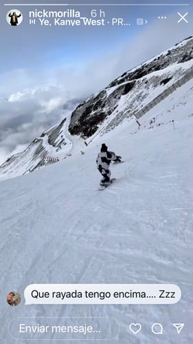 Reviewer snowboarding down a snowy mountain slope wearing the insulated snow jacket.