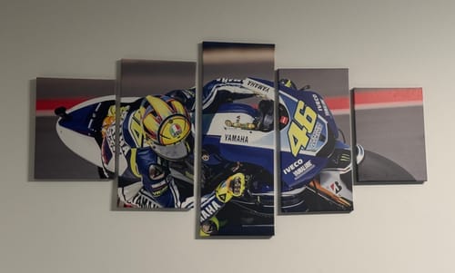 Customer's five-section Valentino Rossi canvas art of a motorcycle racer, mounted on a light-colored wall.