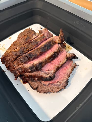 Reviewer's cooked prime rib made with the kit, thickly sliced and showing a pink, medium-rare center.