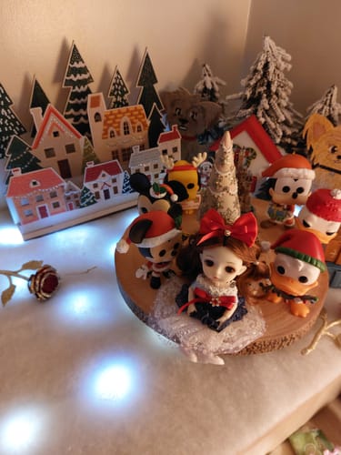 Reviewer's 'Village' 3D Crystal Art Scene displayed with festive figurines and lit from behind.