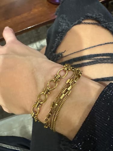 Reviewer's wrist showing three gold-colored bracelets from the advent calendar.